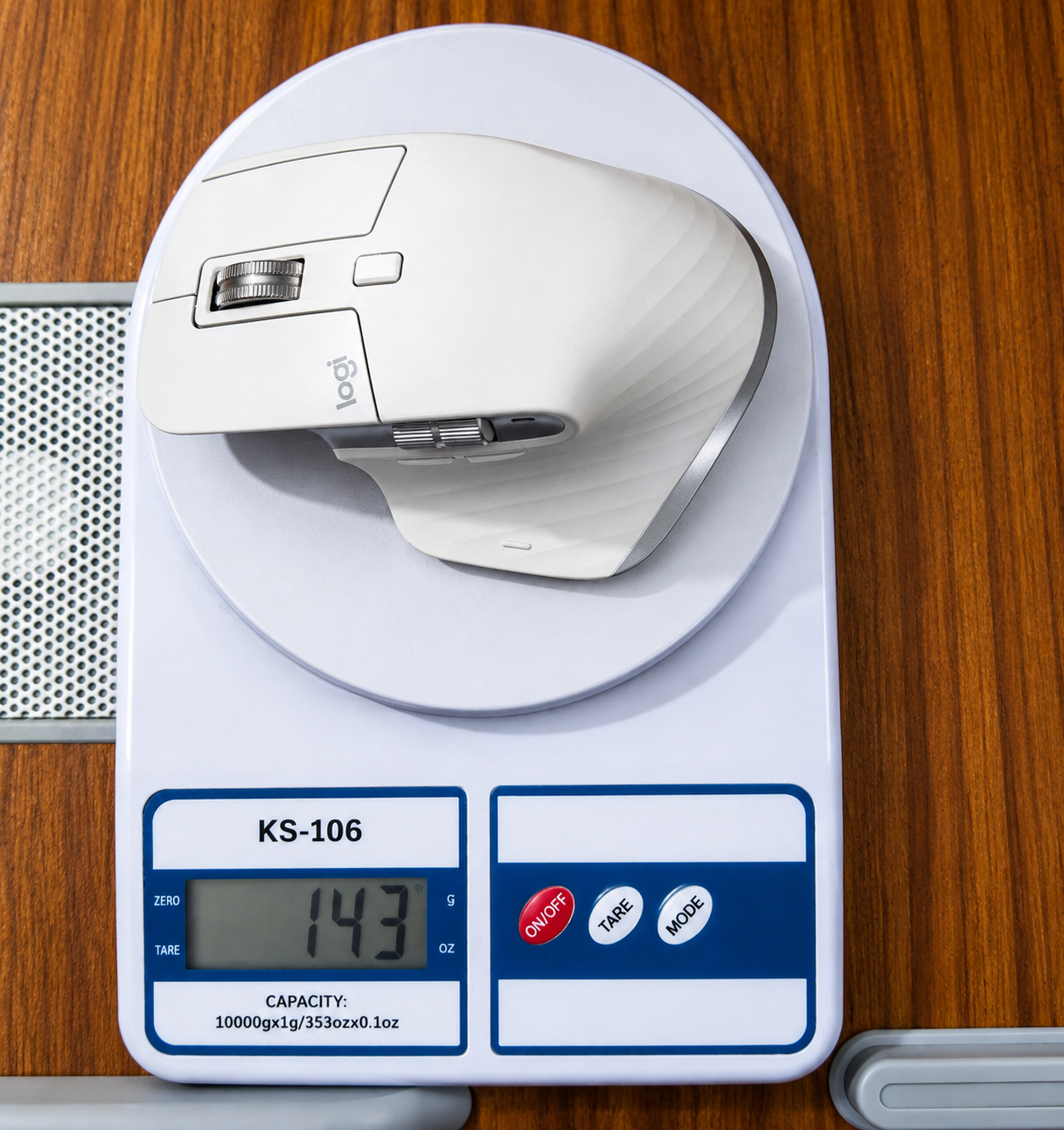 Logitech MX Master 3S placed on a digital scale showing 143 grams